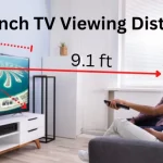 A couple watching their 65-inch TV in their living room at optimal 65-inch TV viewing distance of 9.1 feet.