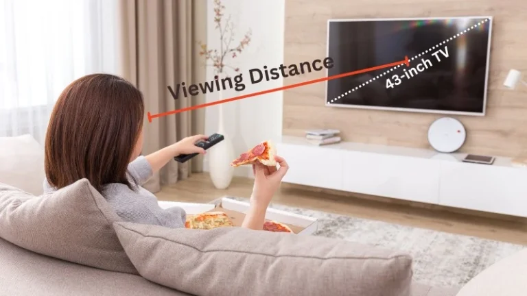 A woman sitting in her living room sofa watching her TV from 43-inch TV Viewing Distance
